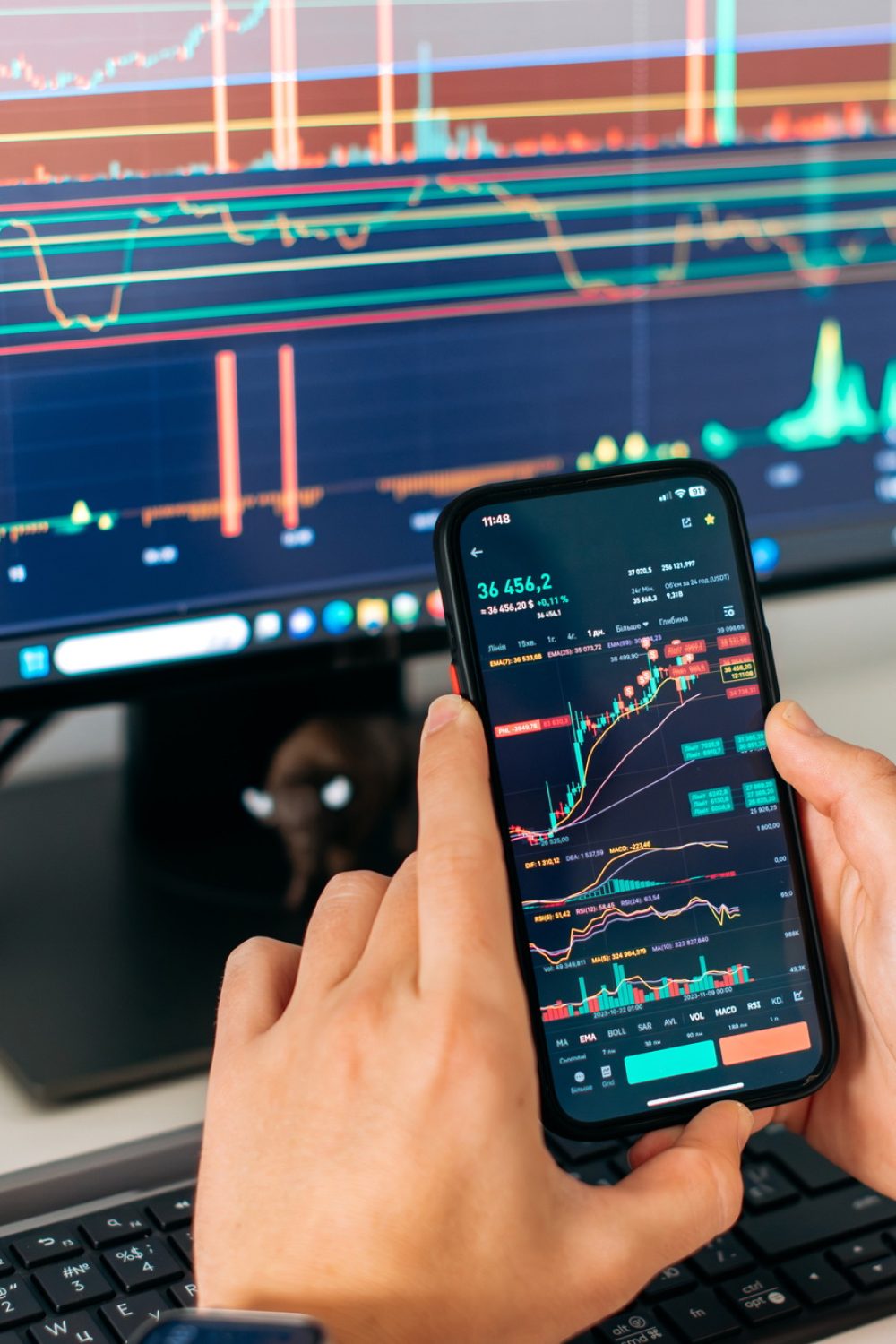 Online trading. Close-up of a smartphone in male hands, with trading data index chart graph on the